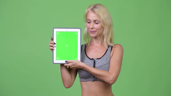 Young Happy Beautiful Woman Showing Digital Tablet Ready for Gym