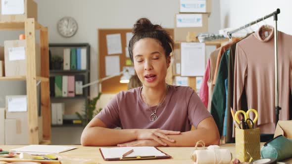 Mixed-Race Female Owner of Clothes Shop Talking at Camera