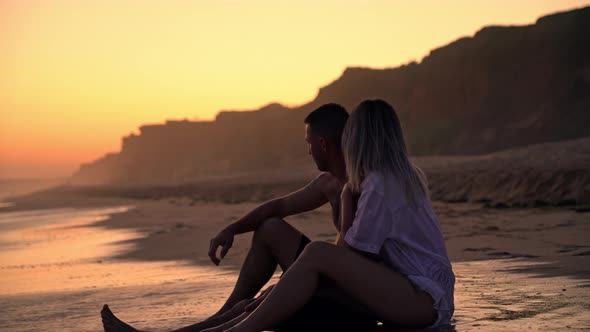 Newlyweds Young Couple on Valentine's Day on a Romantic Meeting By the Sea at Sunset