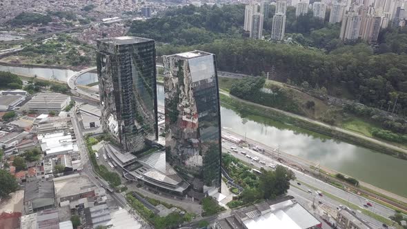 Mirrored two Building and Clouds with cars and river drone 4k