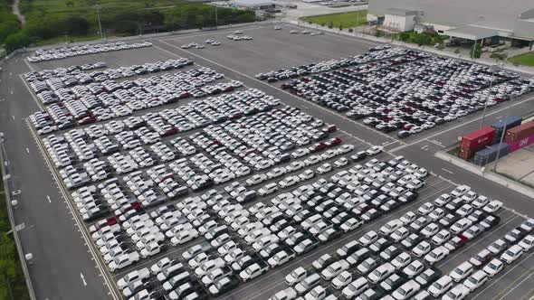 Aerial top view of new cars parking for sale stock lot row, dealer inventory import