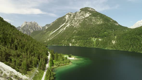 Aerial view of lake with green water near the Cave del Predil, Itally.