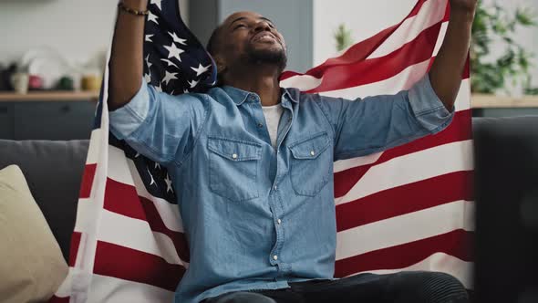 Video of extremely happy man watching TV with USA flag. Shot with RED helium camera in 8K.