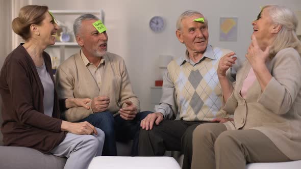 Active Old People Playing Who Am I Game Sitting in Cozy Living Room, Leisure