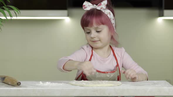 Cooking Pizza. Little Child in Apron Sprinkle the Dough with Flour in Kitchen