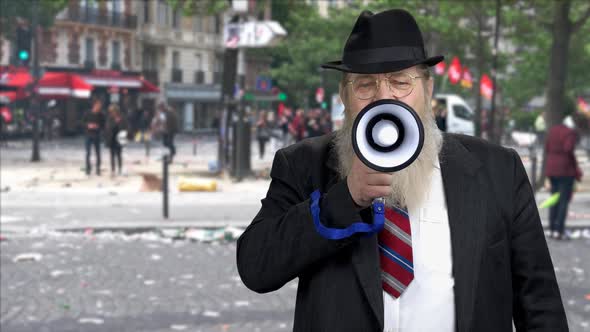 Portrait of Serious Man in Suit Speaking Through Megaphone