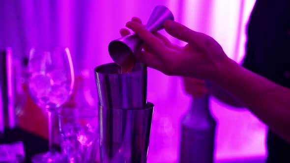 Close Up Hands of the Bartender Making a Cocktail at the Bar Counter