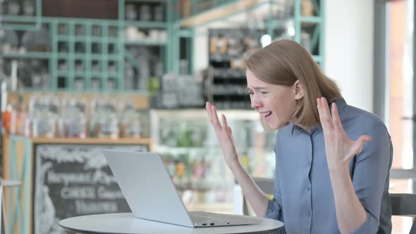 Young Woman Feeling Angry While Using Laptop