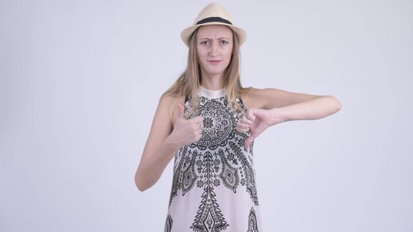 Confused Blonde Tourist Woman Choosing Between Thumbs Up and Thumbs Down