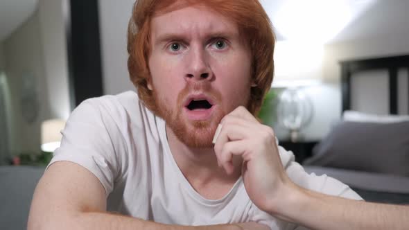 Reacting to Loss Casually Sitting Redhead Man Close Up