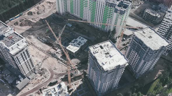 High cranes on construction site with skyscrapers. Construction of modern apartment buildings