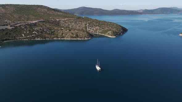 Aerial view of a sailing boat at sunrise in Dubrovnik, Croatia.