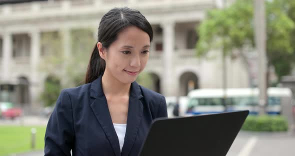 Business woman use of notebook computer at outdoor