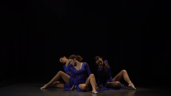 Three Professional Ballerinas Are Dancing in Twilight at Studio