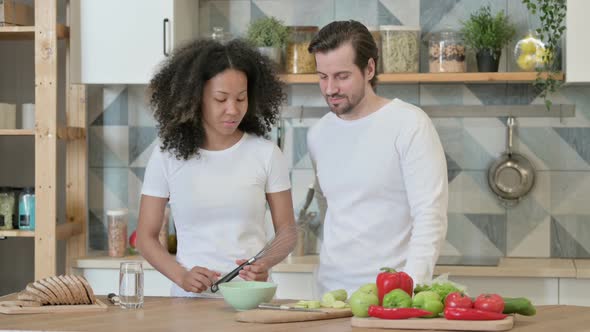 Mixed Race Couple Talking in Kitchen