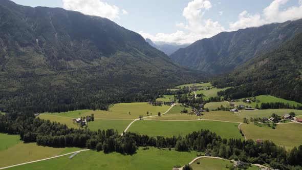 Aerial view of the village, fields and forest in mountains Alps Austria