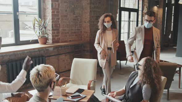 Team of Coworkers in Face Masks Meeting