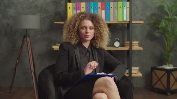 Attentive Female Mental Health Professional Working with Patient at Office