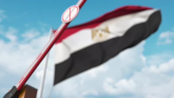 Closing Barrier with STOP CORONAVIRUS Sign at Flag of Egypt