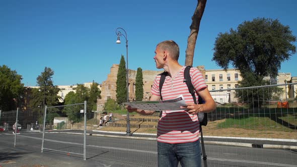 Man Looking at Map with Landmarks in Rome, Italy