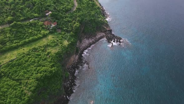 Flight Over a Tropical Ocean Cliffside Full of Greenery Lush on Summer Day