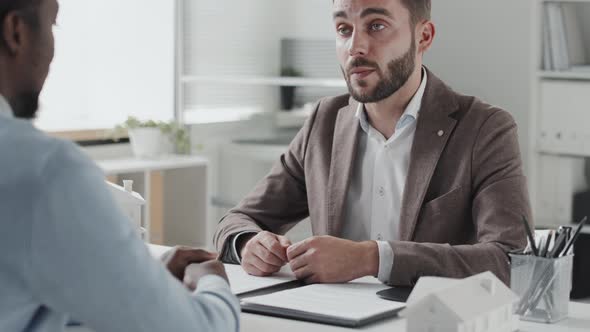 Lawyer Consulting Client in Office