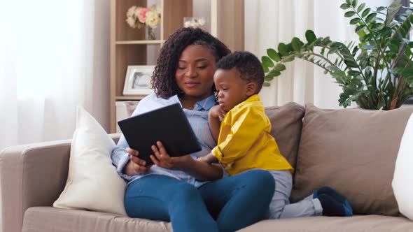 Mother Using Tablet Pc with Baby Son at Home 12