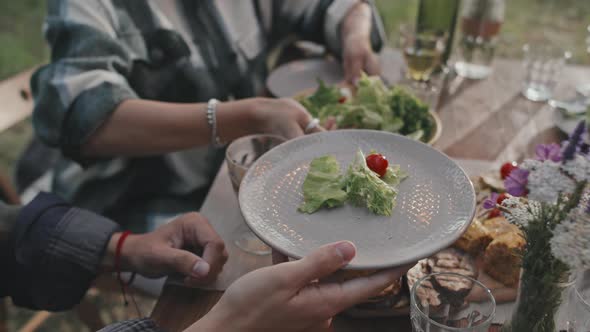 Serving Food to Guest at Picnic