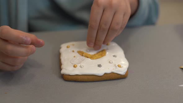 Close Up View of Kids Hands Decorating Homemade Cookies for Holidays