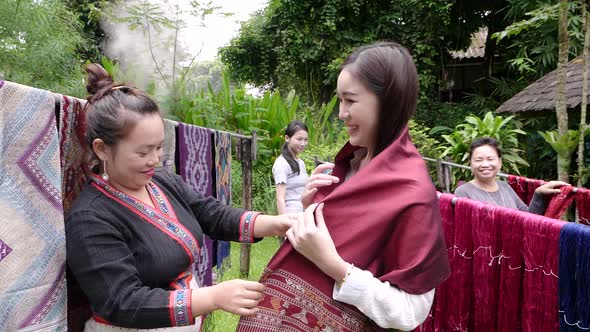 Woman Trying Traditional Laos Fabrics Patterns