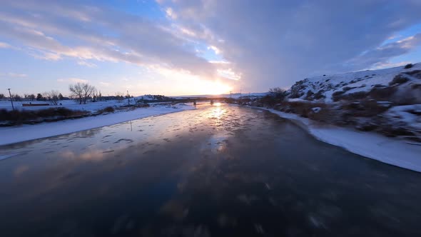 Frozen Ice River Winter Sunset Aerial Shot with Fpv Drone Rocky Mountain Scene