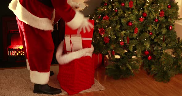 Santa delivering gifts under christmas tree 4k