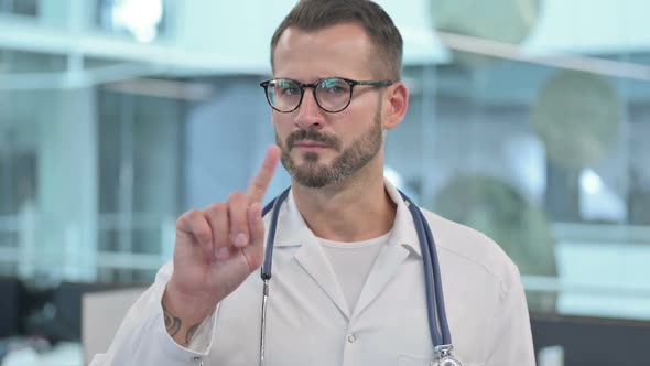 Middle Aged Male Doctor Showing No Sign By Finger