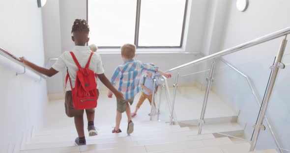 Video of diverse boys walking on stairs at school