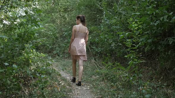 Female walking in the forest slow-mo footage