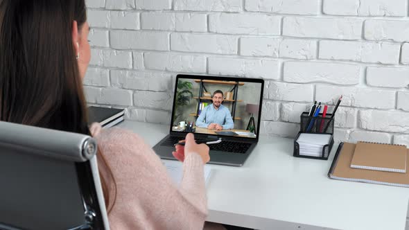 Woman at Home Study Online Video Call Laptop Listen Teacher Writes in Notebook