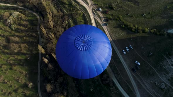 Blue balloon in the sky over the countryside area