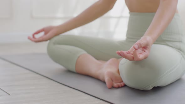 Close up hands of Wellness woman doing yoga lotus pose at in the morning to deep breath