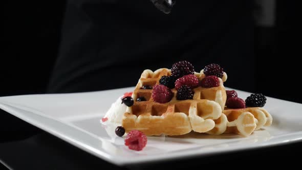 Delicious Holiday Wafers with Raspberries and Blueberries Served on White Plate. Slow Motion Food