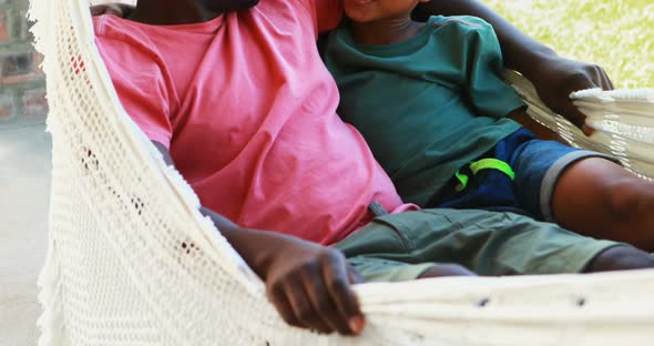 Father and son relaxing on a hammock