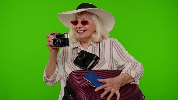 Mature Woman Photographer Traveler in Sunglasses Taking Picture Photos on Retro Camera Chroma Key