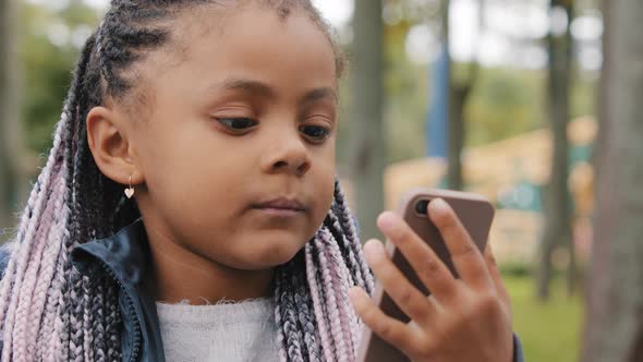 Closeup Little Multiracial Girl Child with Pigtails Make Video Call Outdoors African American Kid
