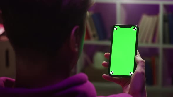 Man Using Smartphone with Chroma Key in Evening