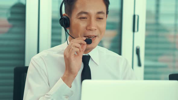 Businessman Wearing Headset Working Actively in Office