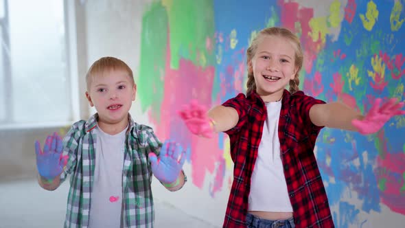 Children Playing Colors Home During Renovation Girl Braces Boy Down Syndrome Smiling Showing To