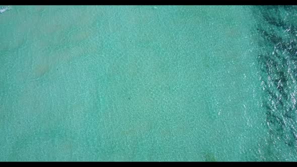 Aerial flying over texture of exotic bay beach trip by blue sea and white sand background of adventu