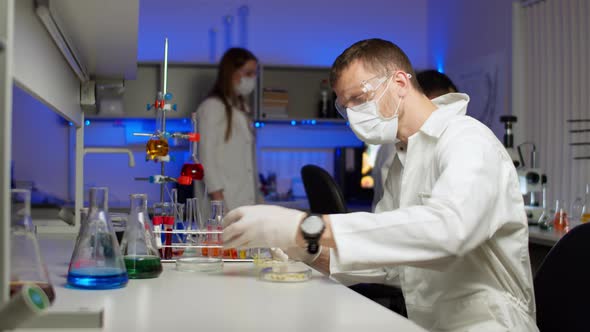 Scientist Examining Sprouts in Petri Dish