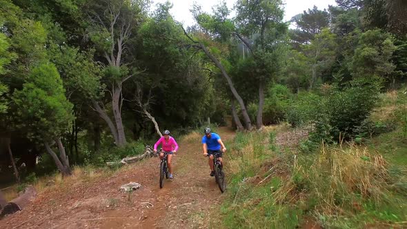 Hiker couple cycling in the forest