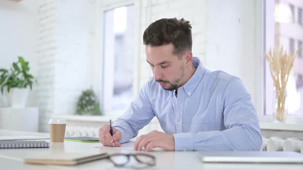 Creative Man Writing on Paper at Work, Paperwork