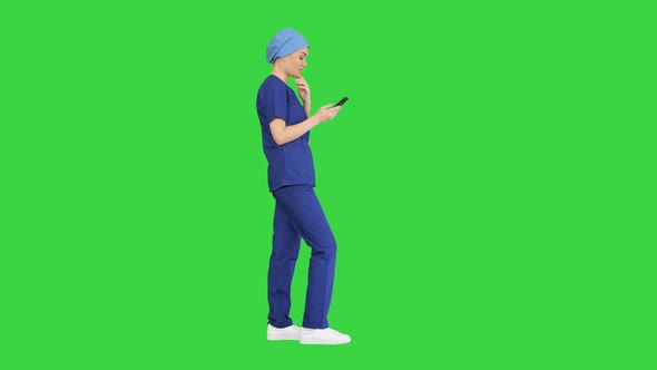 Thinking Female Doctor Using Her Smartphone on a Green Screen Chroma Key